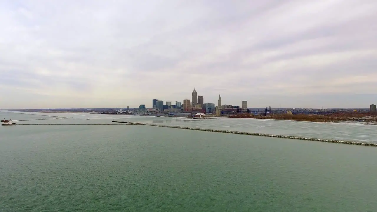 Wide revealing drone shot of downtown Cleveland Ohio and Lake Erie