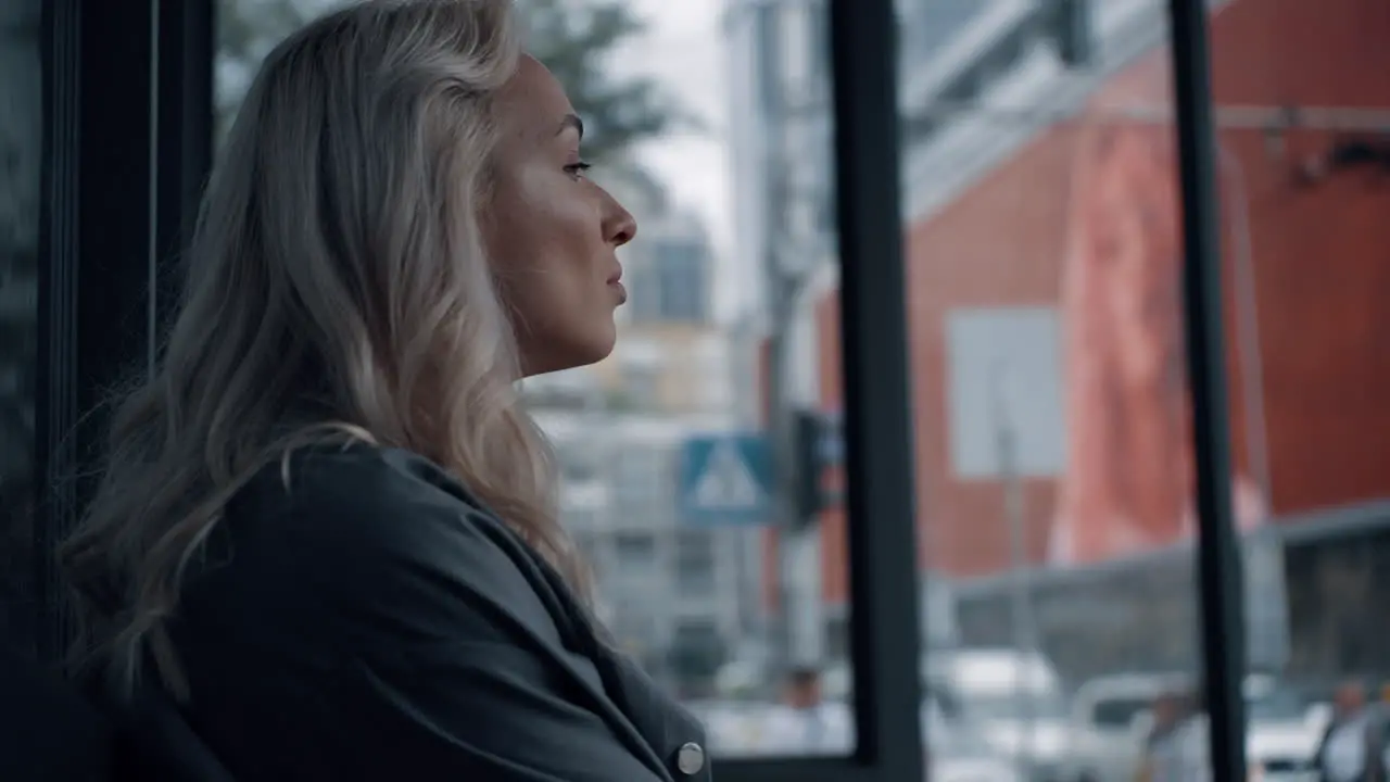 Business woman waiting ride in city background with skyscraper or office