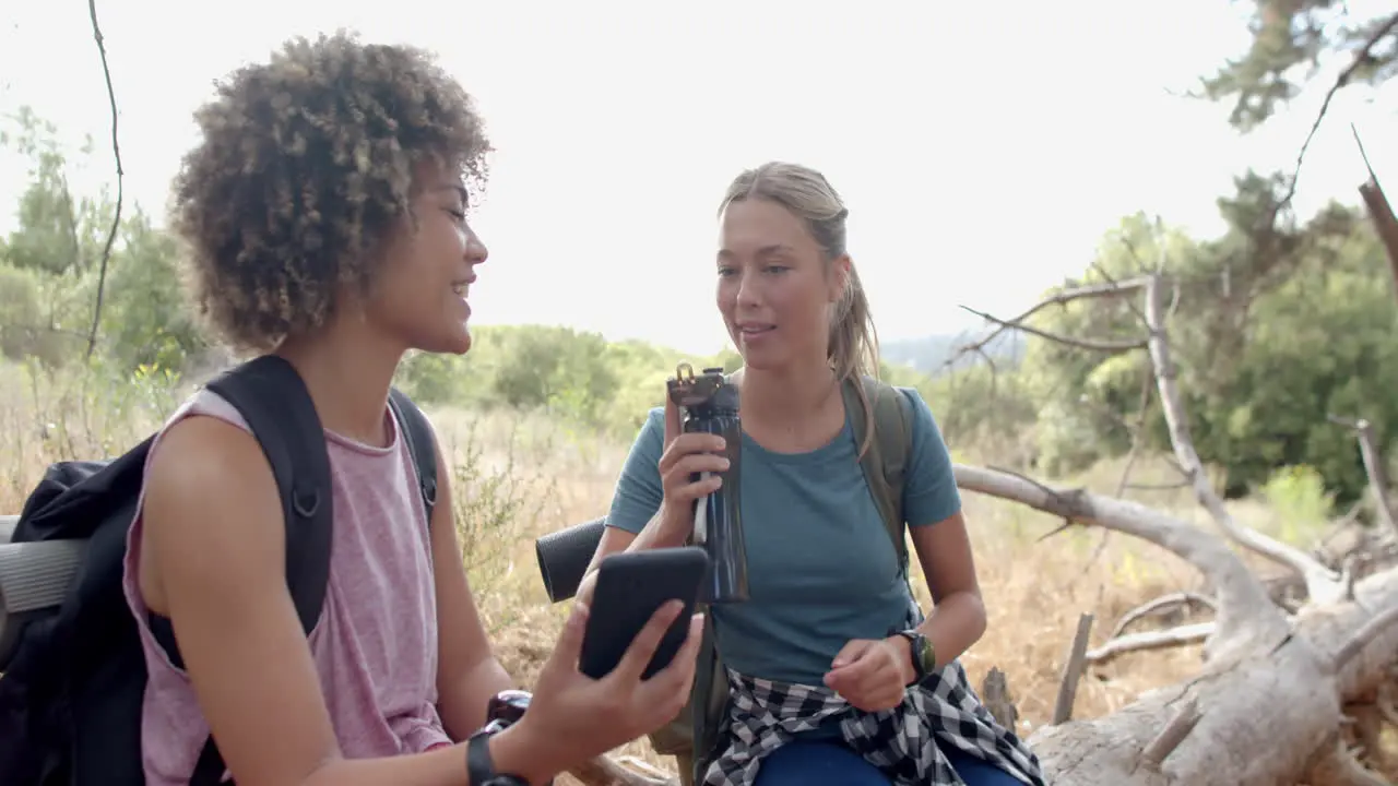 Biracial woman and Caucasian woman share a conversation outdoors