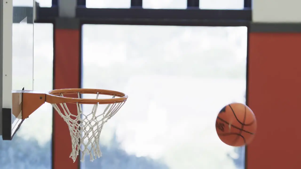 Flying ball in indoor basketball court in slow motion