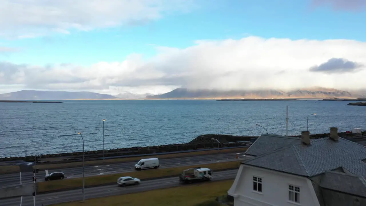 Landscape of Reykjavik over coastline panning drone shot