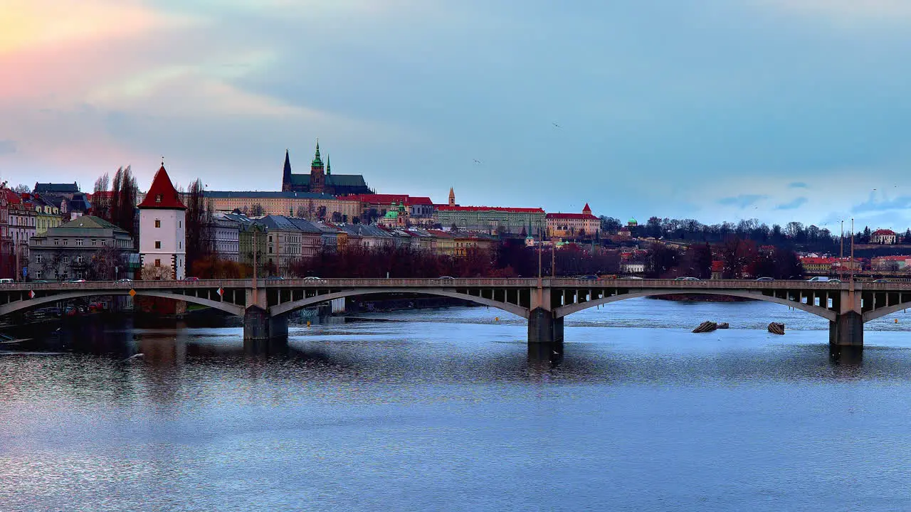 Jirásek bridge over Vltava river with traffic and Prague city skyline