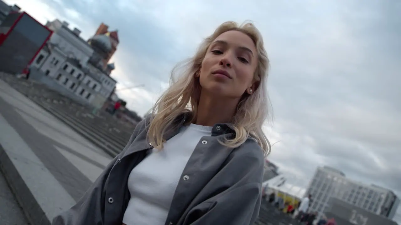 Fashion girl posing city landscape at evening downtown street