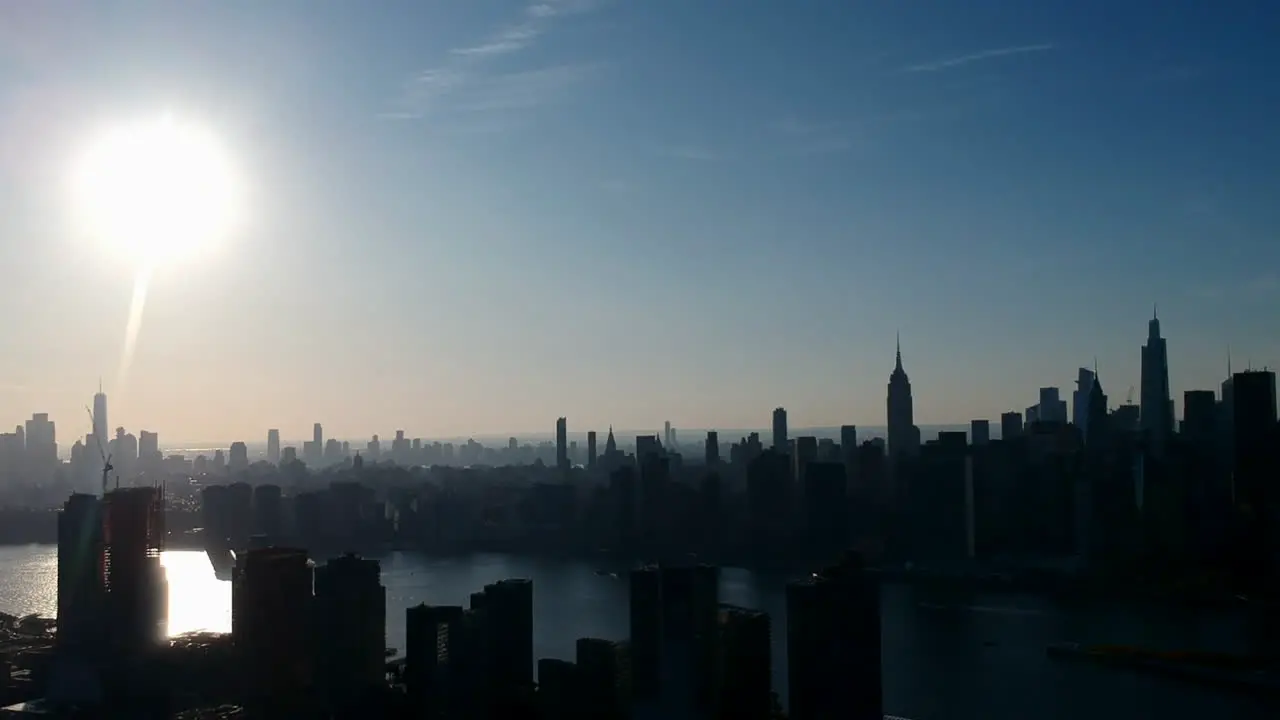 Silhouettes On City Landscape Against Bright Sunlight In The Sky During Sunset In Hunters Point Long Island New York City