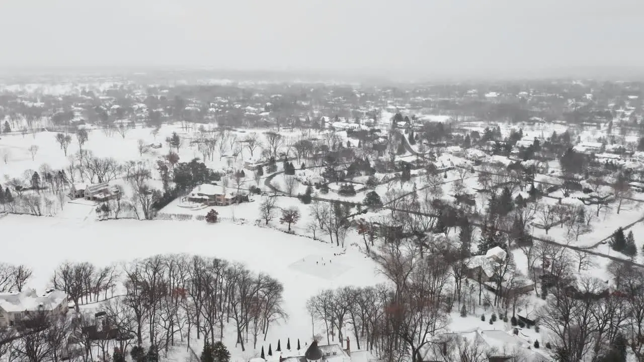 Aerial people skating on a homemade backyard ice rink during winter