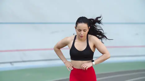 Tired sport woman running on racetrack Portrait of exhausted woman running