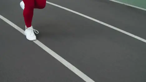 Close up of sport woman legs running at stadium Woman feet running in shoes