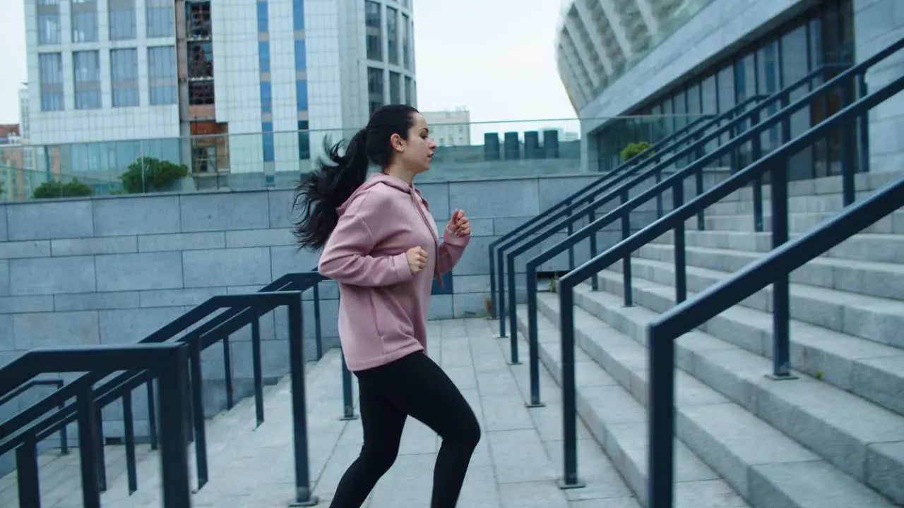 Athlete woman running up stairs on outdoor workout Fit girl jogging upstairs