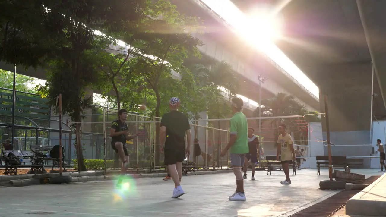 People Playing Sepak Takraw Under Highway in Saphan Taksin District of Bangkok Thailand in Slow Motion