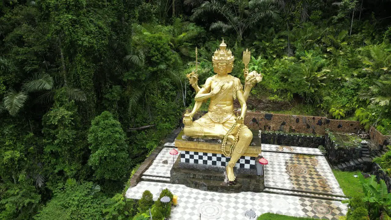 A lesser known golden Buddha statue located in East Bali in the jungle aerial