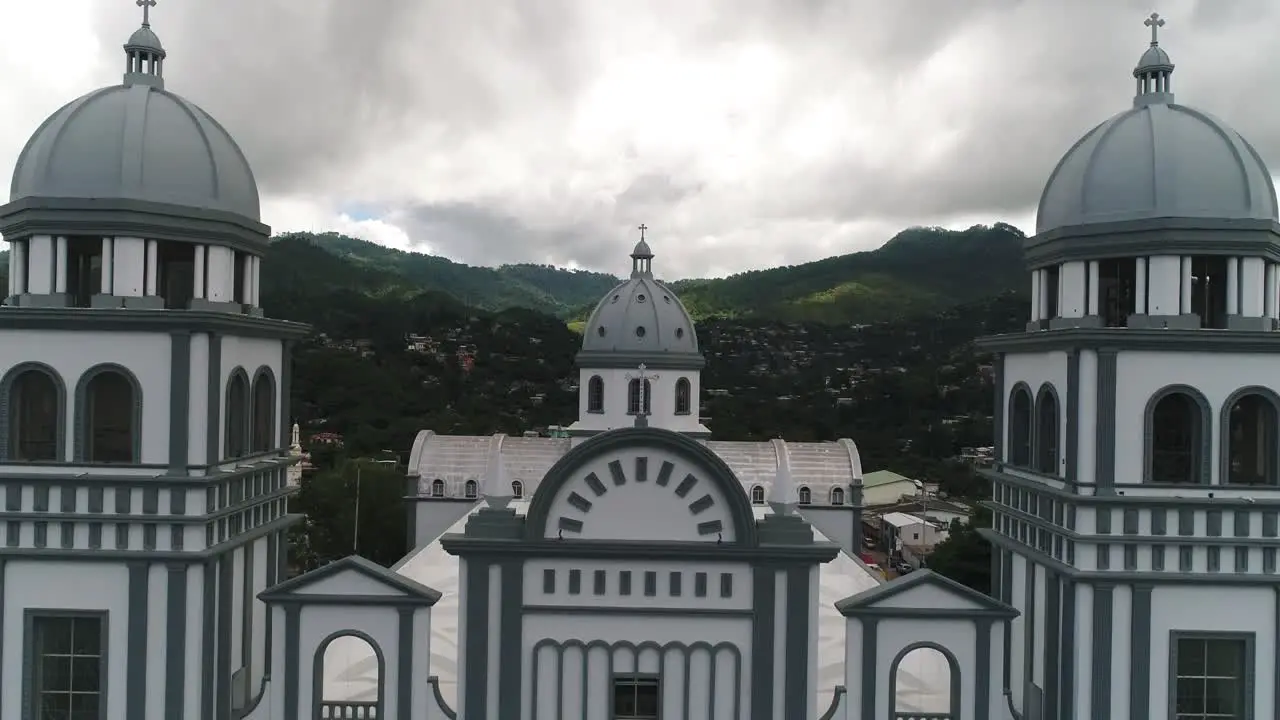 AERIAL Aerial zoom out of cathedral overlooking city and mountains