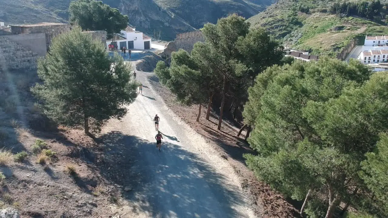 People running a mountain marathon on arid roads