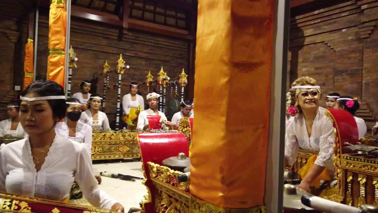 Balinese Hindu temple beautiful females performing Gamelan ancient tradition part of religious and artistic music expression among the people of Bali Indonesia travel and tourism