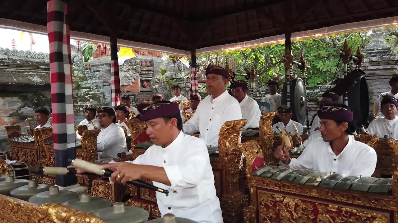 Gamelan Music Orchestra Performs Elegantly at Bali Hindu Temple Ceremony during Daylight Indonesian Traditional Art