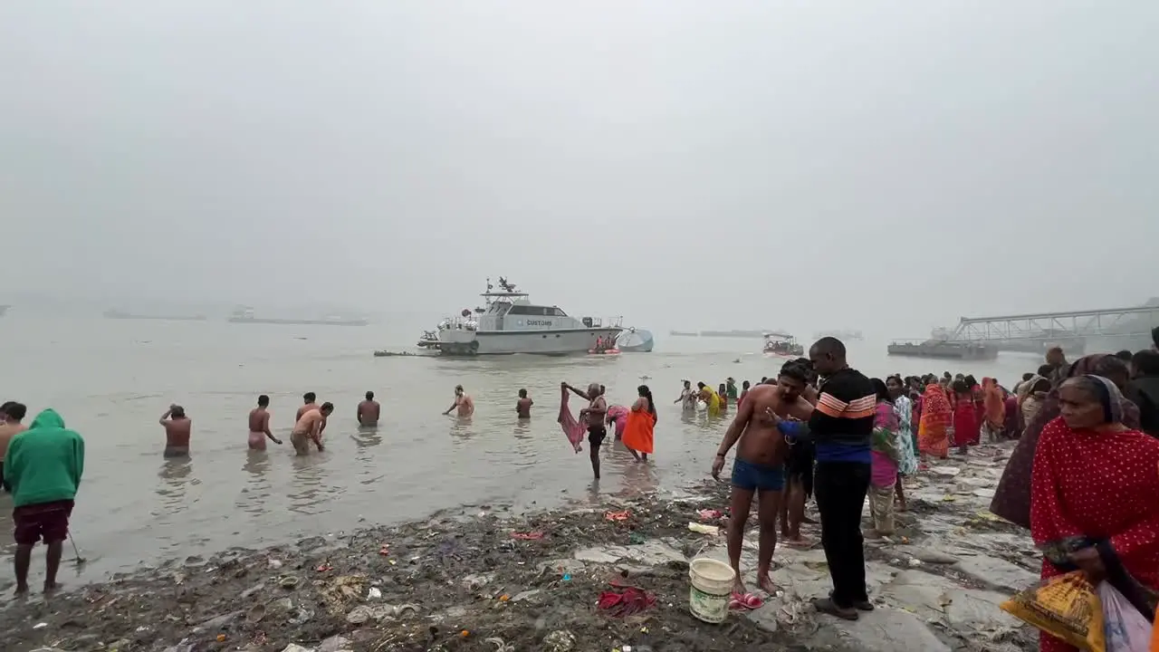 Wide shot of Hindus bathing in Babu ghat in Kolkata for the celebration of Sankranti festival