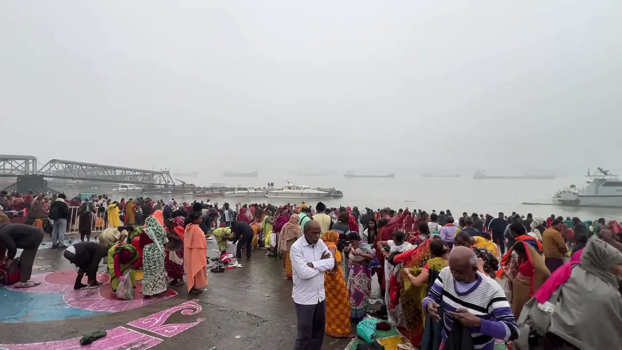 Hindus bathing in Babu ghat Kolkata for the celebration of Sankranti festival on a foggy day in India