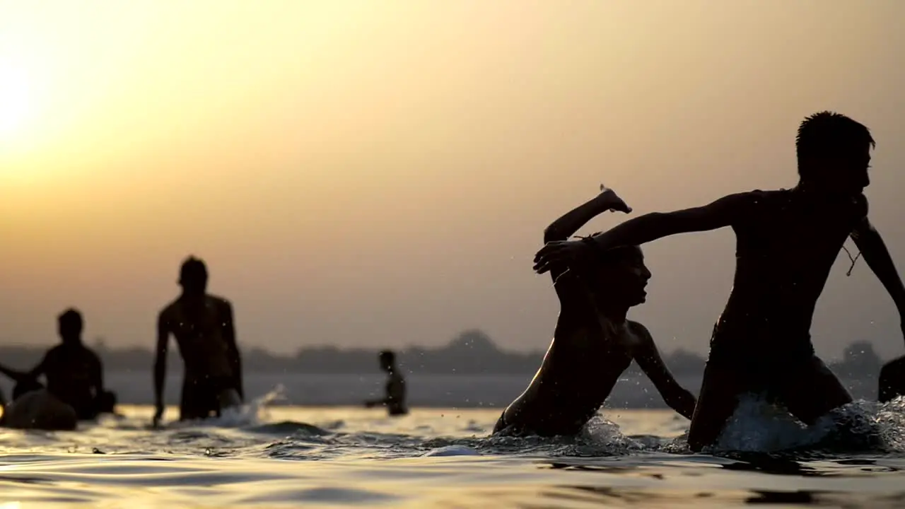 Silhouetted People Bathing in Ganges