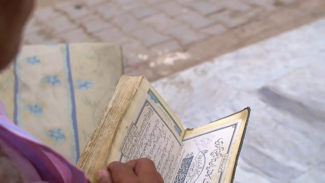 Man Looking Through Quran