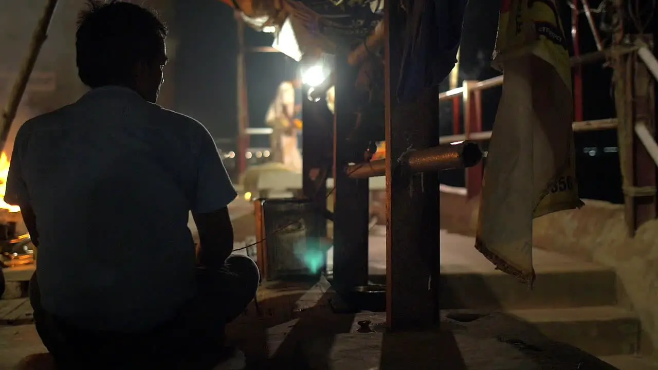 Man Ringing Bell at Night Ceremony