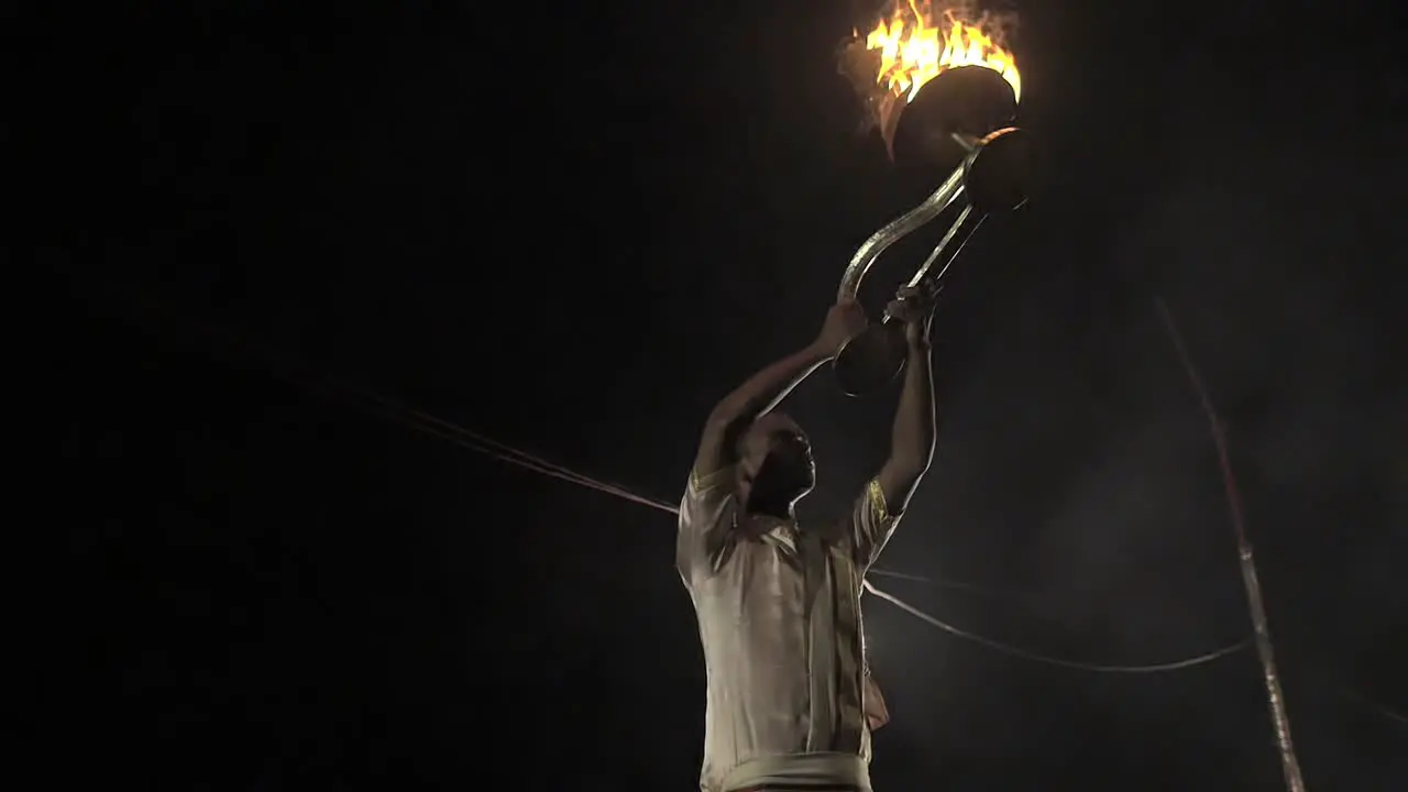 Indian Man Lifts Up Ceremonial Candles