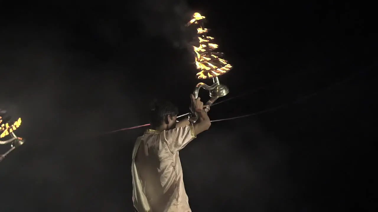 Tracking Shot of Men Waving Ceremonial Candles