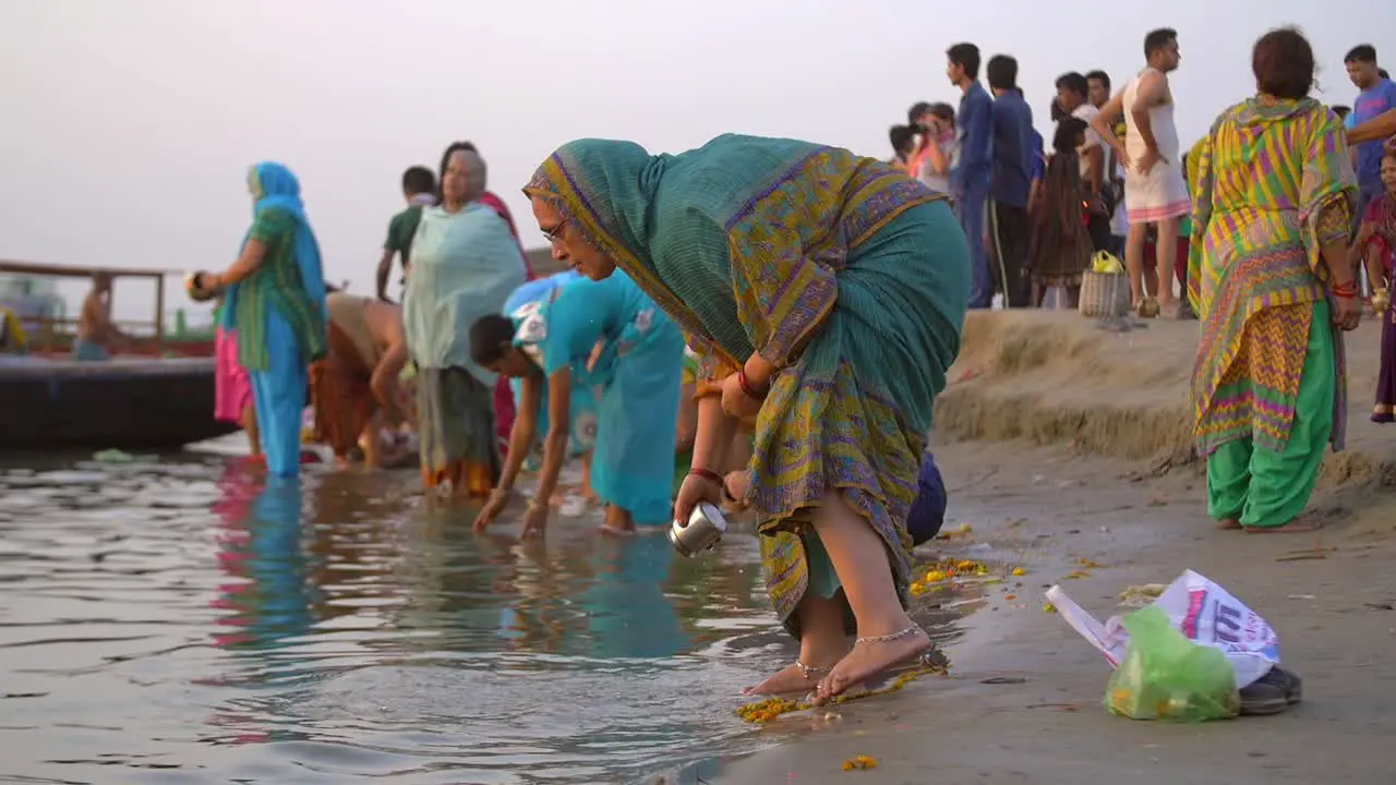 Woman Scooping Up Water From the Ganges