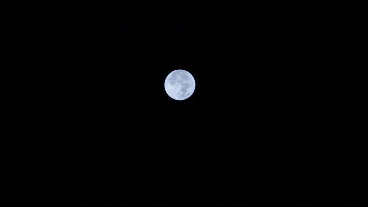 close up of the full moon in the middle of dark