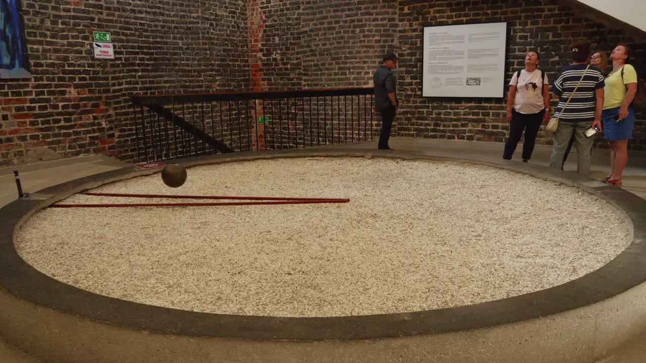 Tourist At Foucault's Pendulum Inside The Ancient Planetarium Bell Tower On Cathedral Hill Frombork