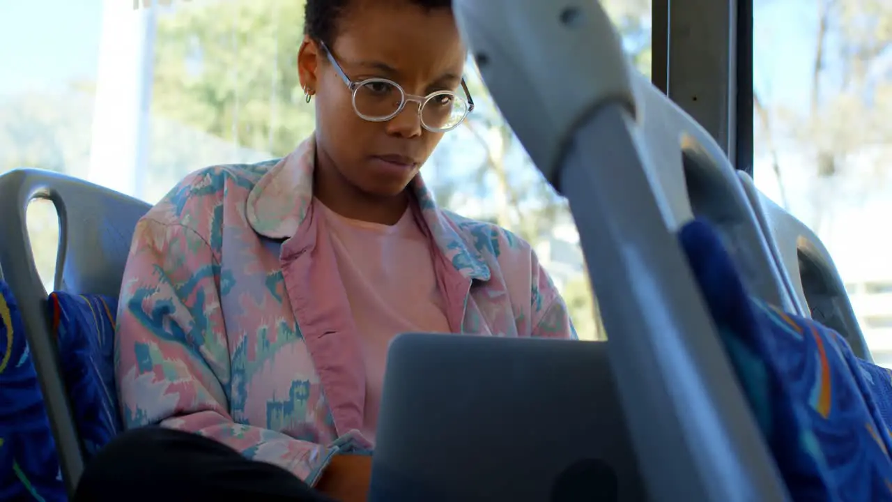 Female commuter using laptop while travelling in bus 4k