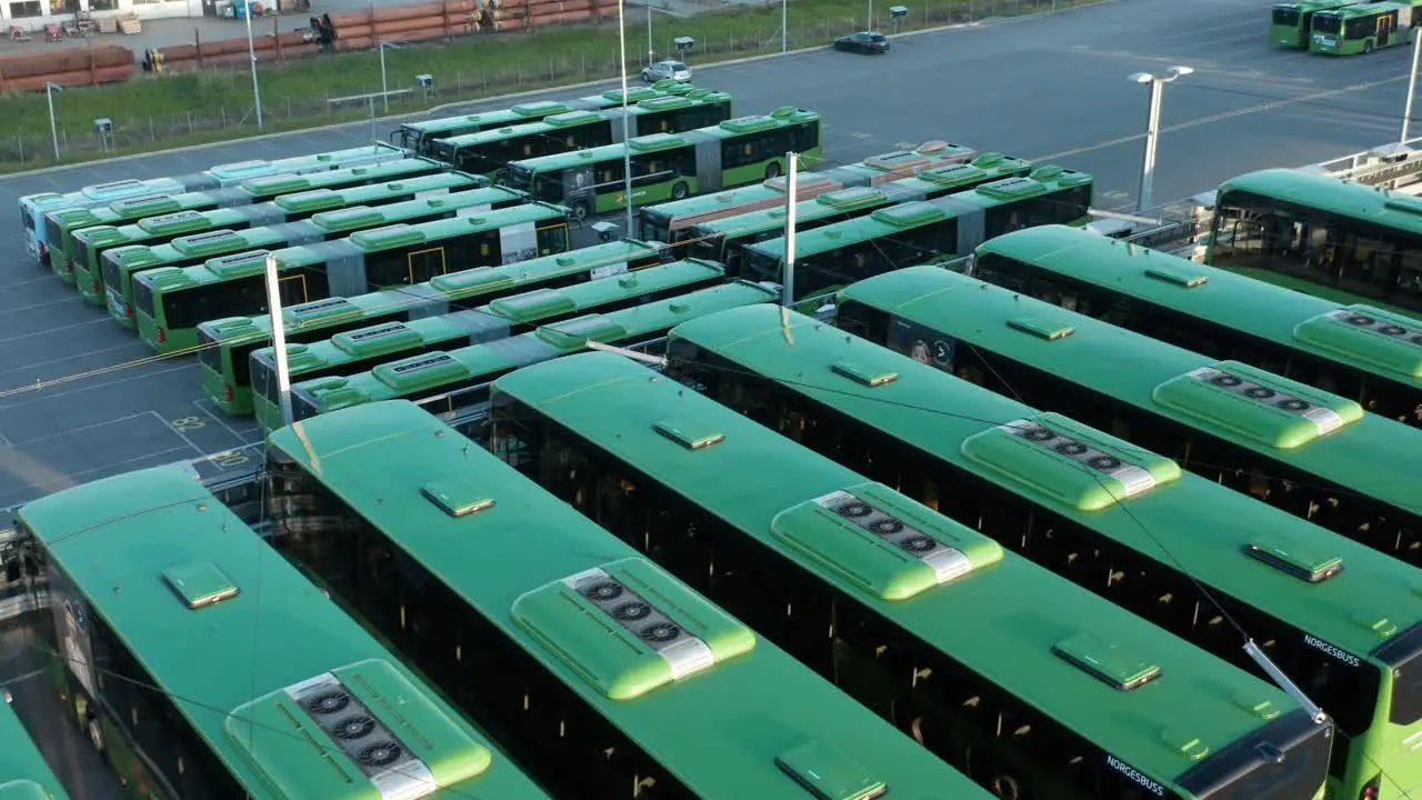 Aligned Green Electric Buses in bus Park Drone Aerial View