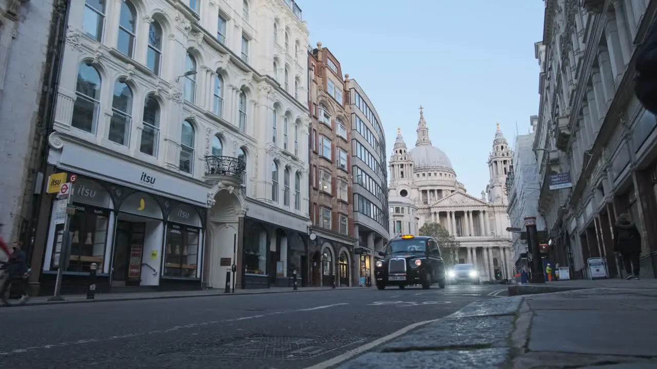 NBFL London bus and black cab passing in front of st pauls cathedral from ludgate hill road