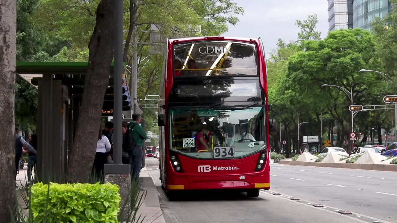 People climb aboard Metrobus in Mexico City