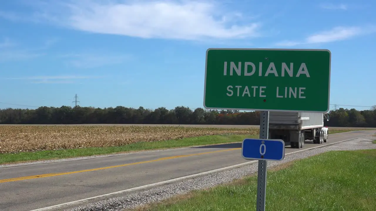 Sign Indicates The Indiana State Line As A Truck Passes On A Rural Road