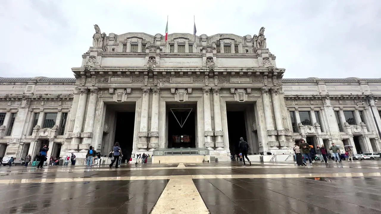 Static shot of Milan Central train station exterior building with tourists