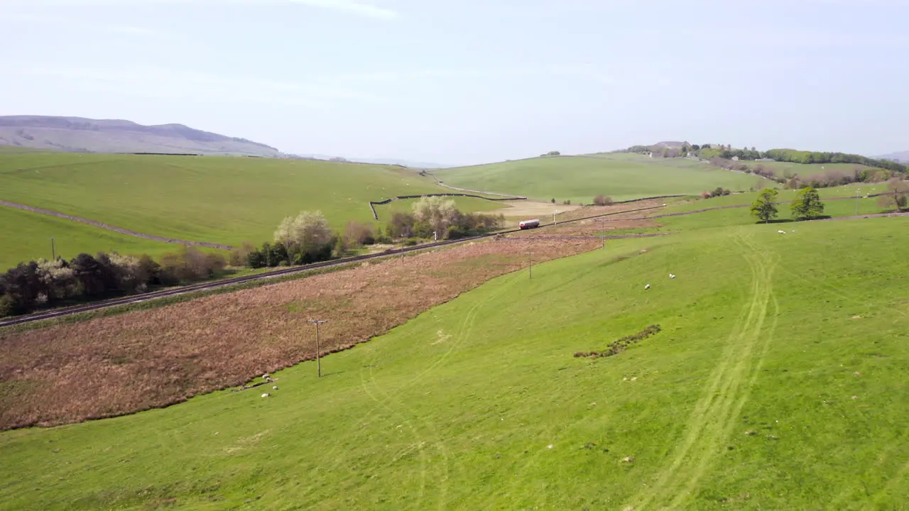 Aerial Dolly Shot of a 1903 Electric Autocar Train as it passes through the Yorkshire Dales on a Sunny Summer’s Day