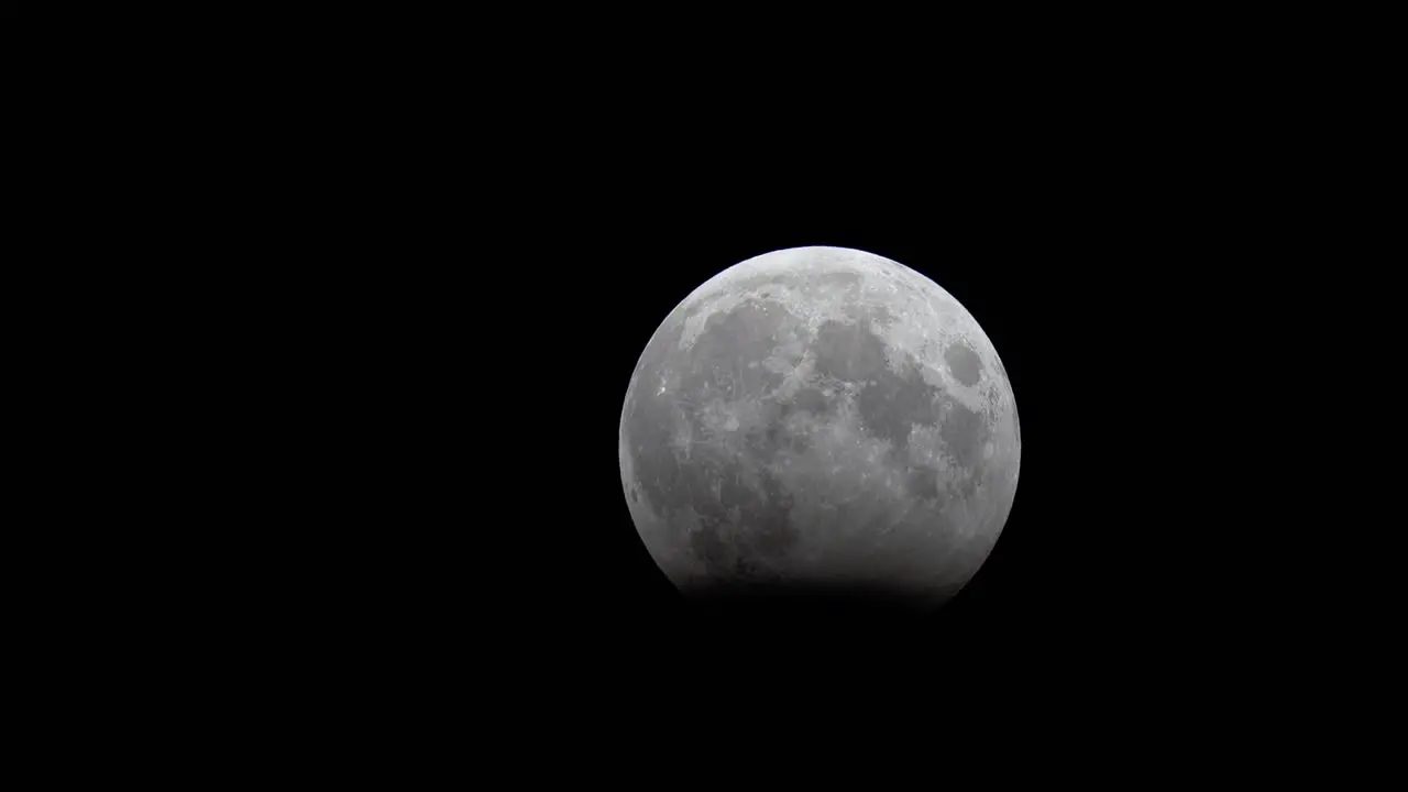 Lunar eclipse progresses in clear night sky October 2023