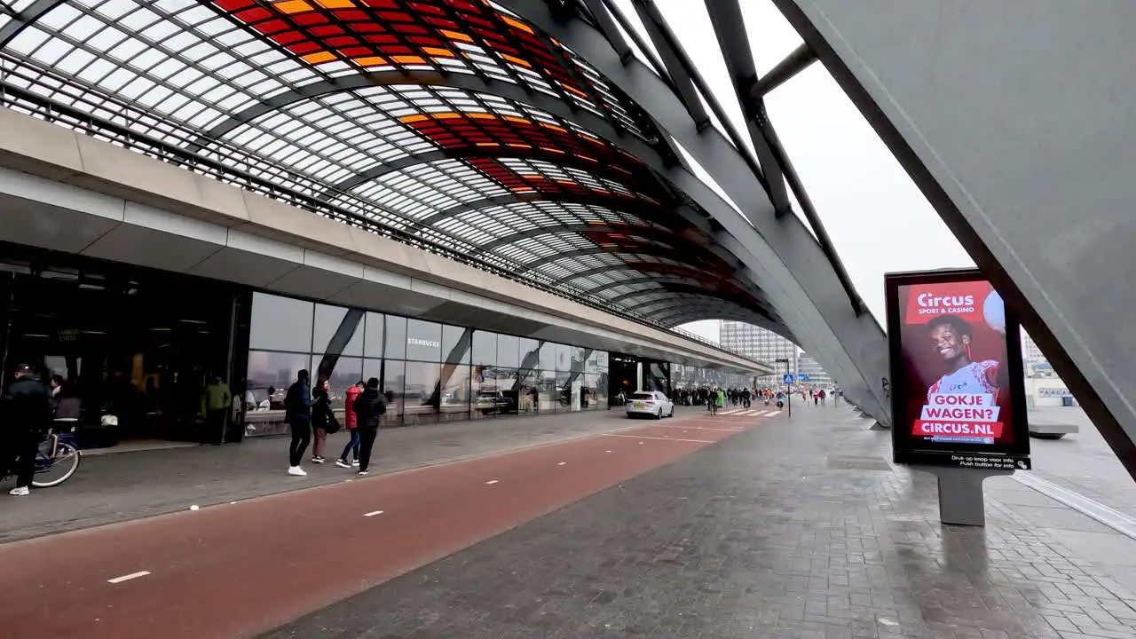 A busy bicycle lane outside of the Amsterdam Central Station as people go about their day commuting on their bicycles in the busy urban city Amsterdam Netherlands