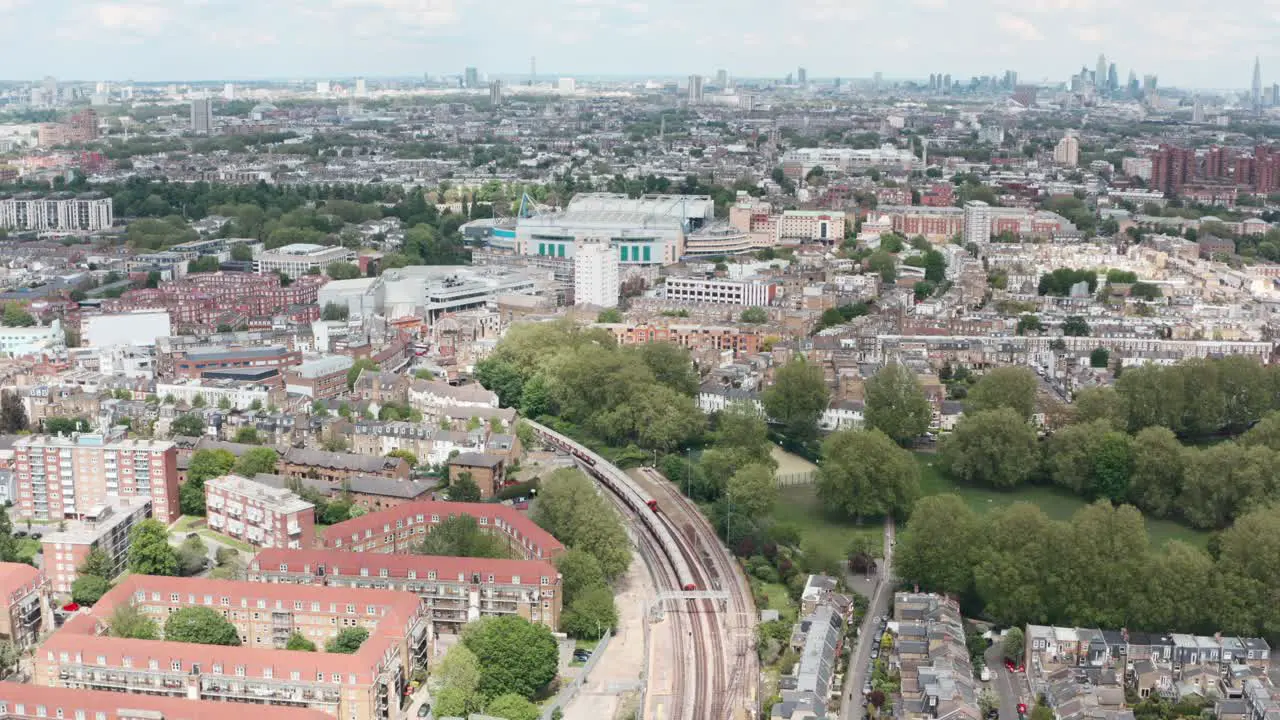 Drone shot over district line underground trains towards Stamford Bridge chelsea stadium London