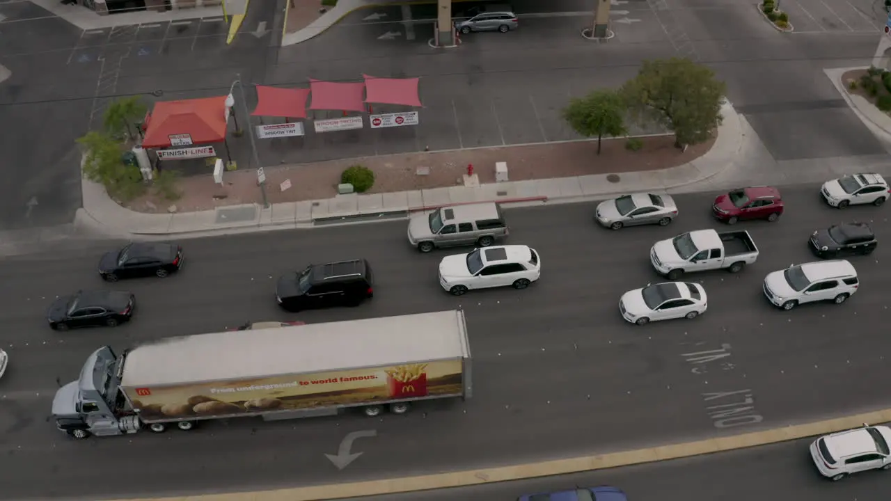 Large truck turning left at a busy intersection opposite a gas-petrol station