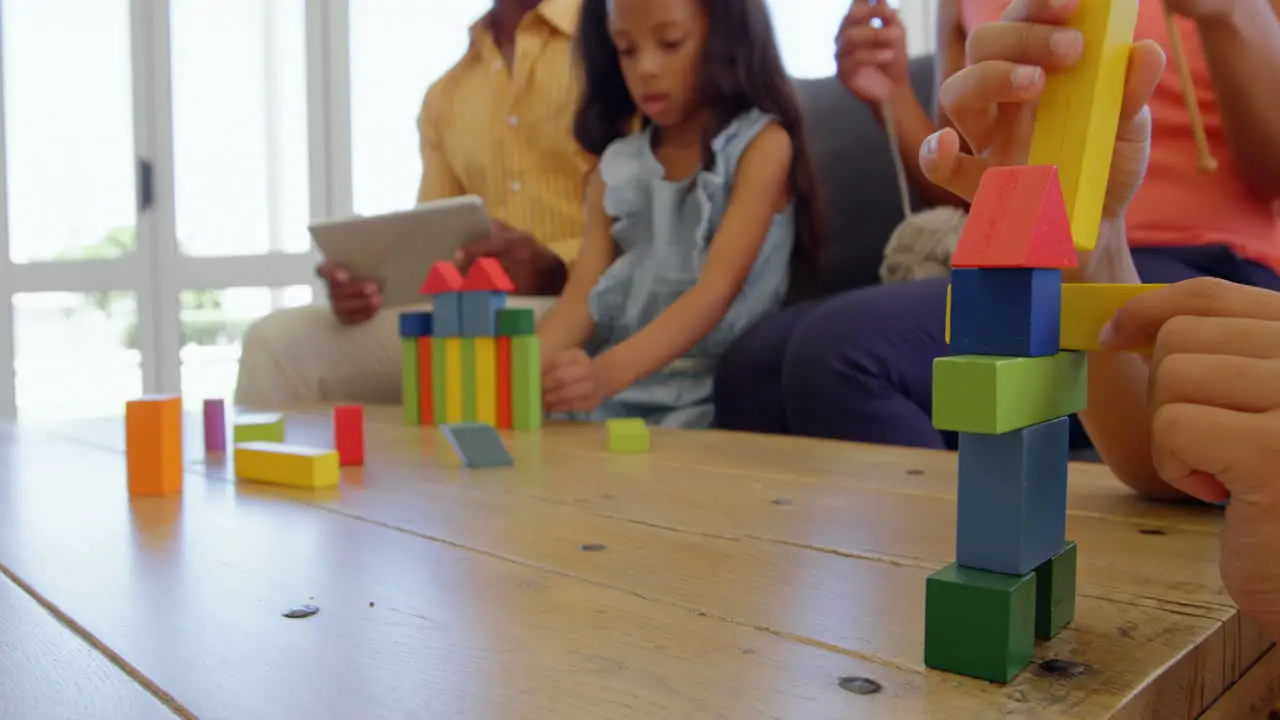 Children playing with building blocks on table in a comfortable home 4k