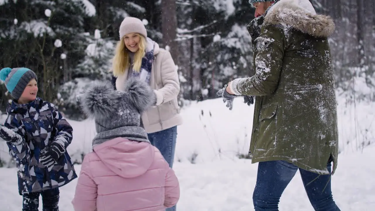 Handheld video of family having snowball fight