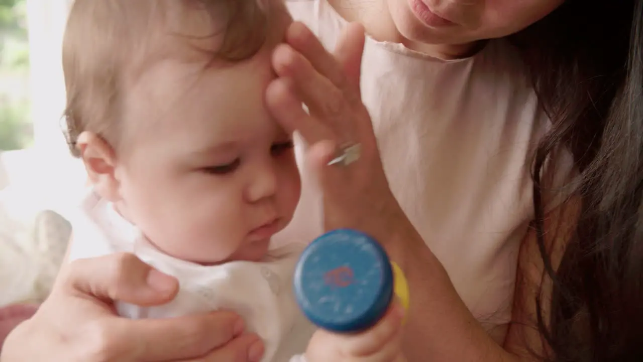 Mother And Baby Playing With Colorful Toy At Home