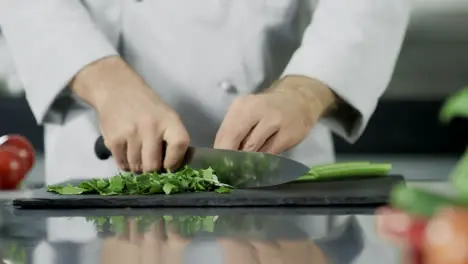 Chef hands cutting celeriac at kitchen Closeup chef hands cooking greenery