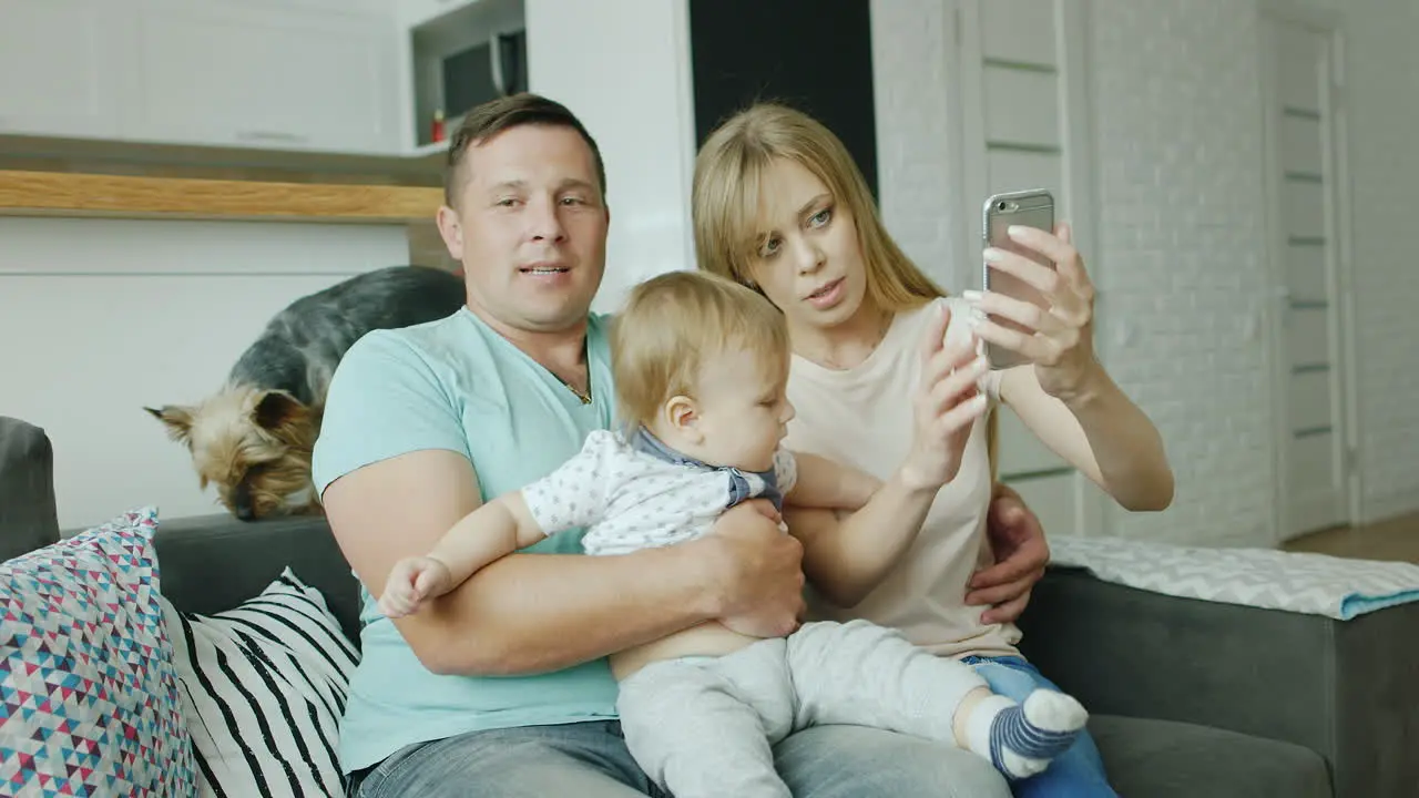 A Young Couple Makes A Selfie Along With Her Baby Boy