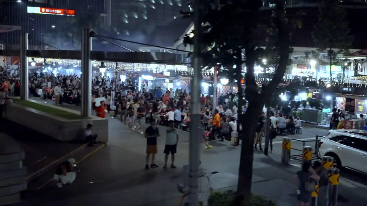 Crowded Food Street At Night In Bustling Financial District Of Singapore