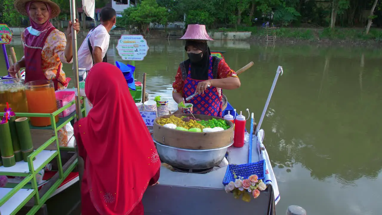 Thai woman selling asian food in Klong Hae floating market