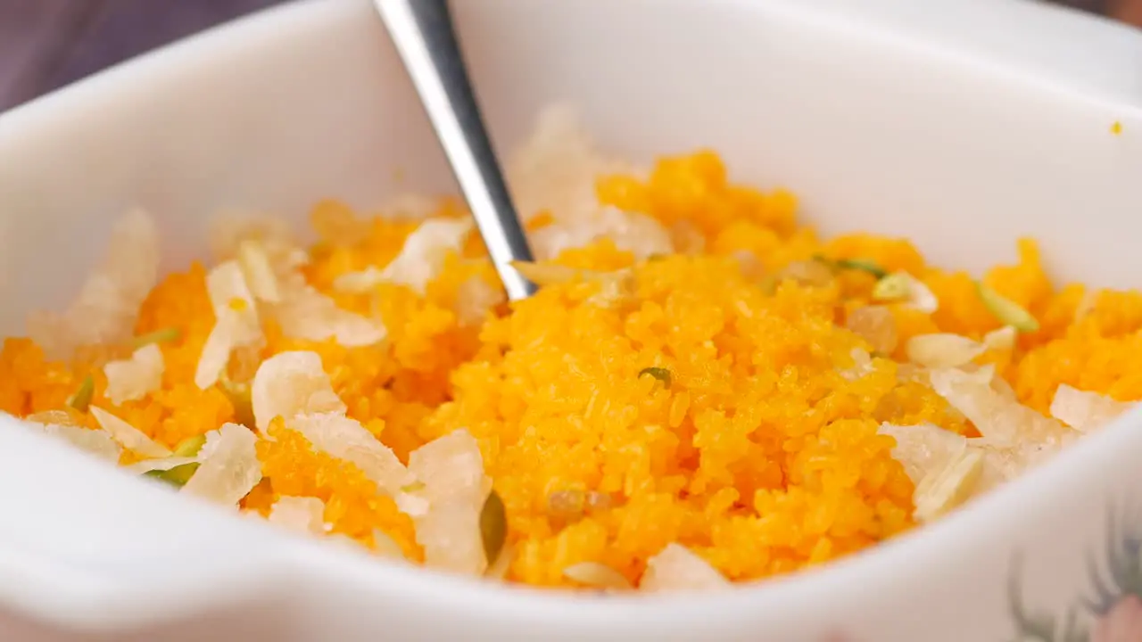 A big white bowl filled with tasty jollof rice served 