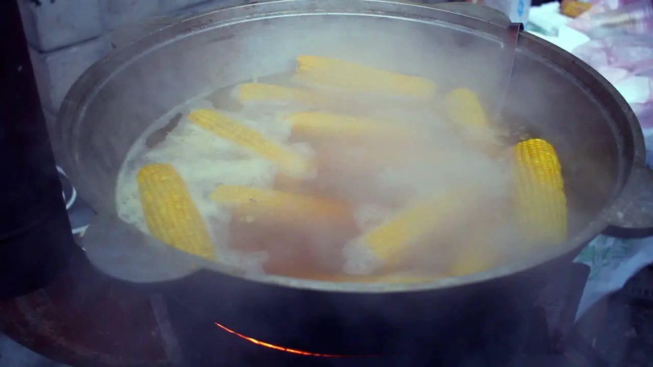 Corn boiled in pan Street food Cooking sweet corn in boiled water