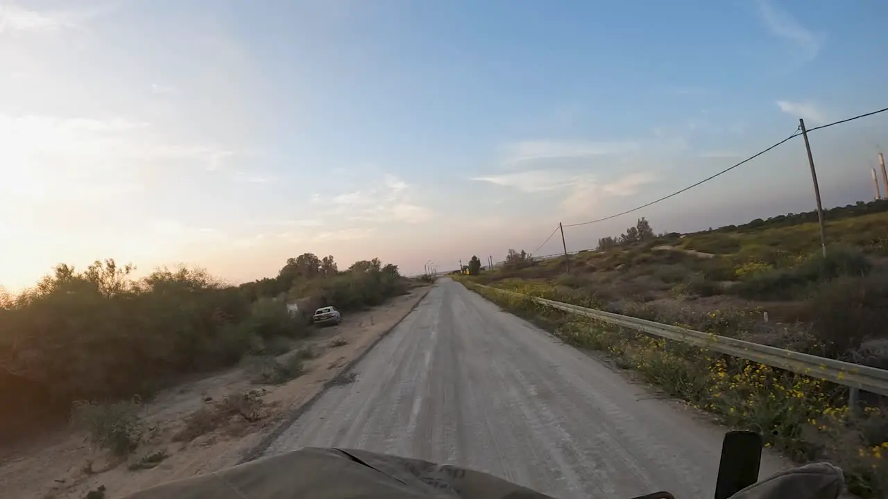 Driving army vehicle in Gaza Strip abandoned car by the road