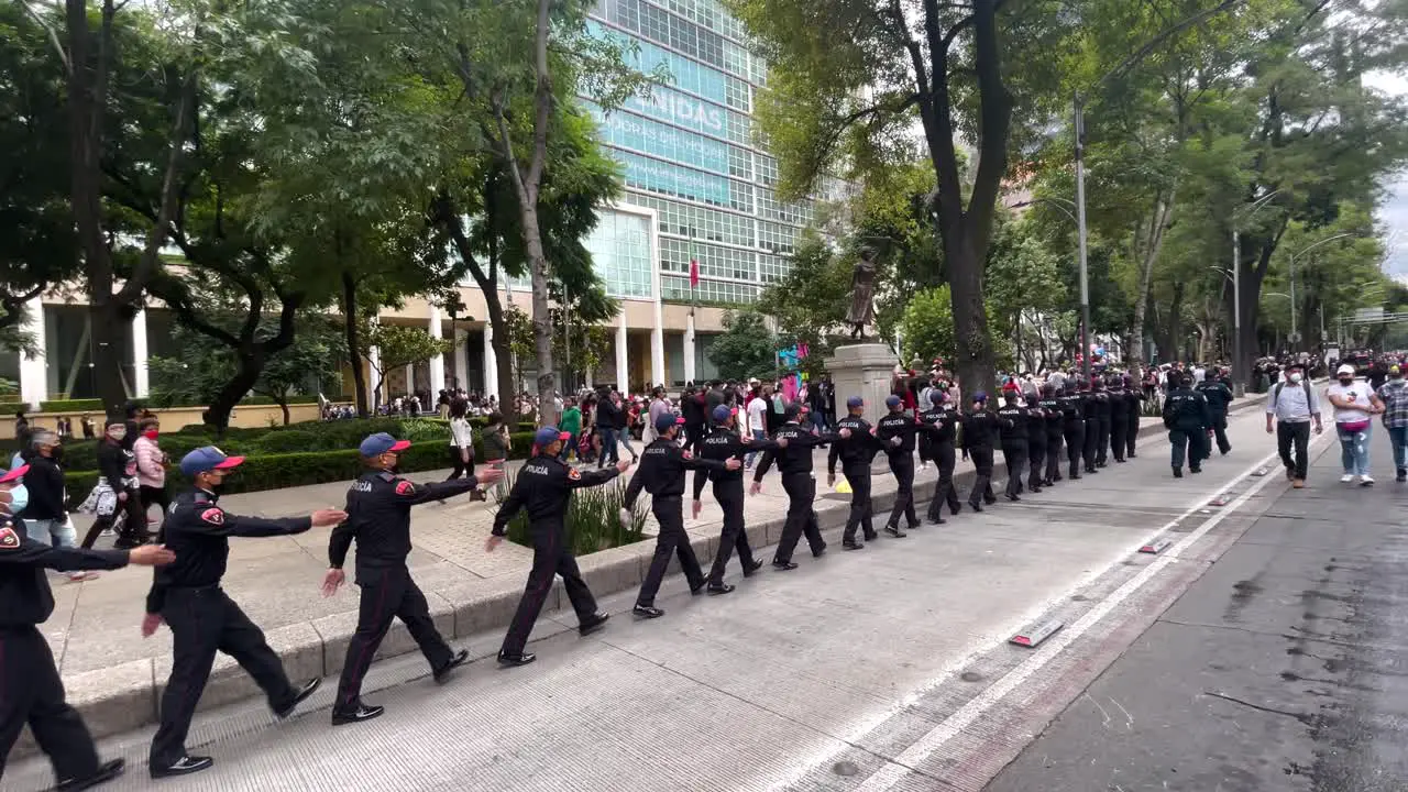 shot of a line of policemen formed during the military parade